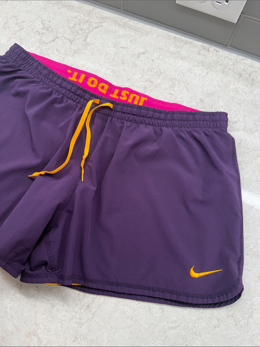 Nike FITDRY Purple Shorts with Pink Waistband and Yellow Accents